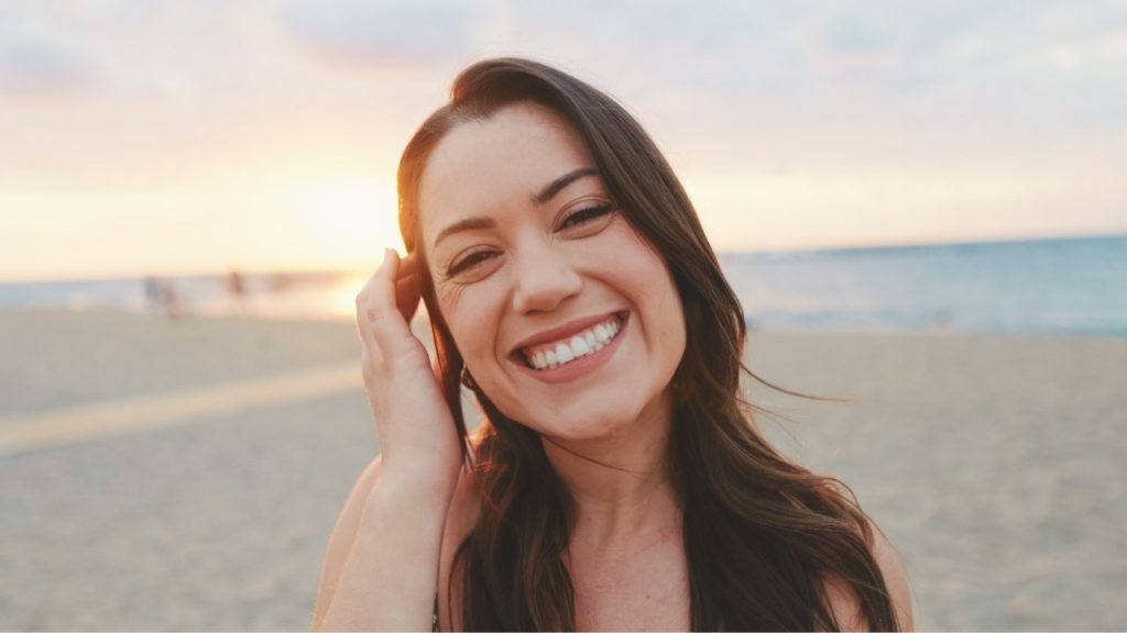 Smiling woman beginning her journey from the first call to recovery