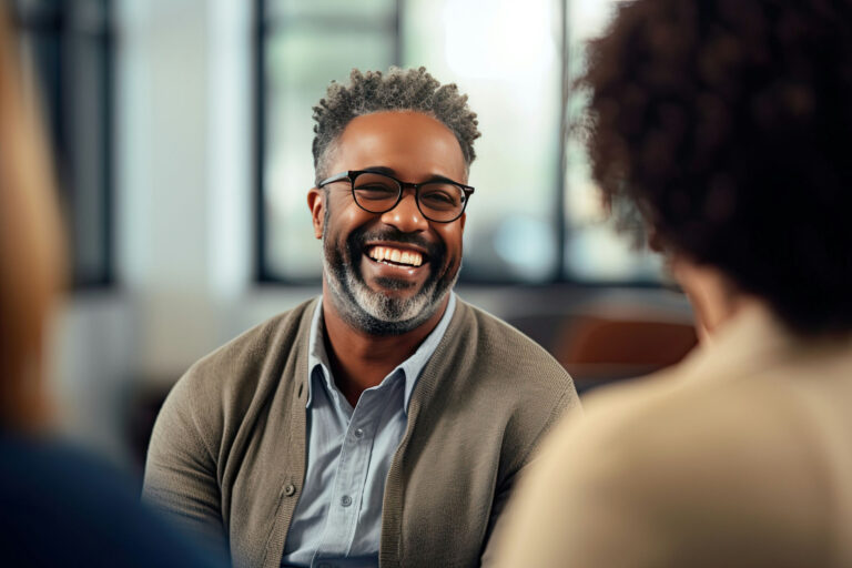 Man laughing in support group discussing detox medication.