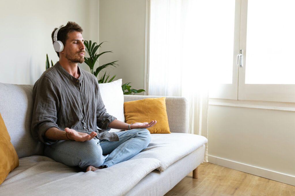Man relaxing with headphones during opioid withdrawal.