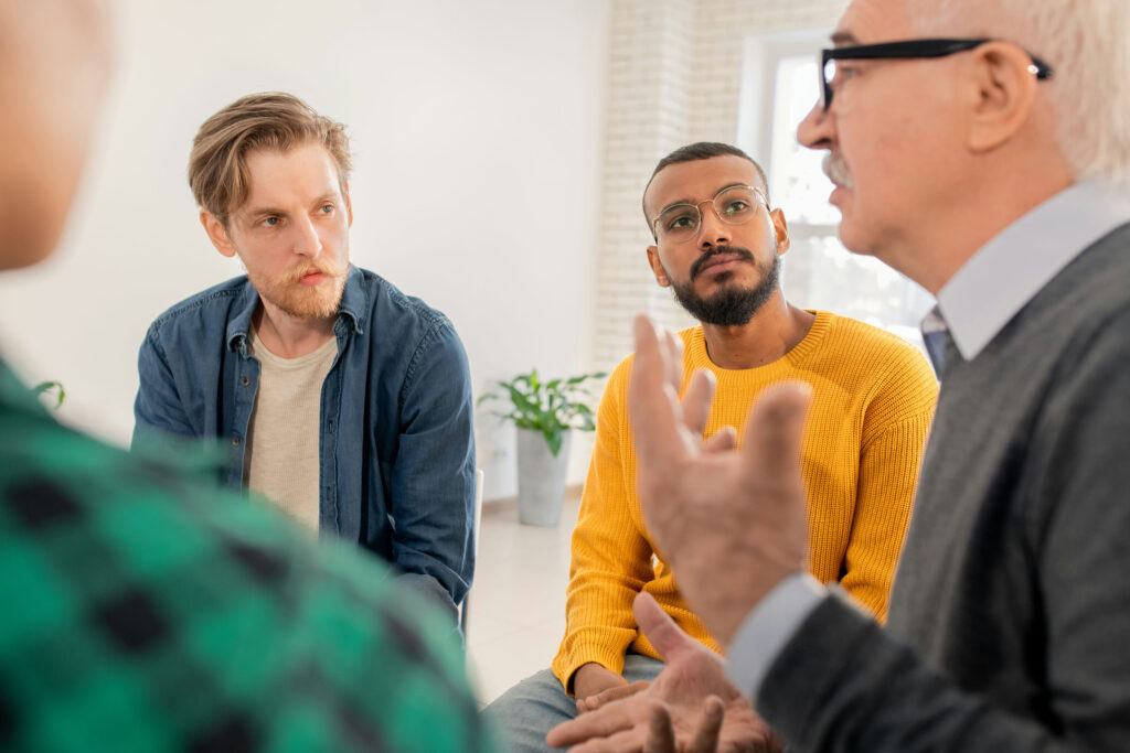 group-of-men-speaking-about-ambulatory-detox